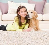 girl and her dog on carpet
